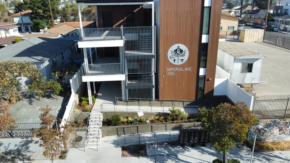 Aerial view of a new multi-family building on Imperial Avenue, San Diego, with street-front landscaping by YKB
