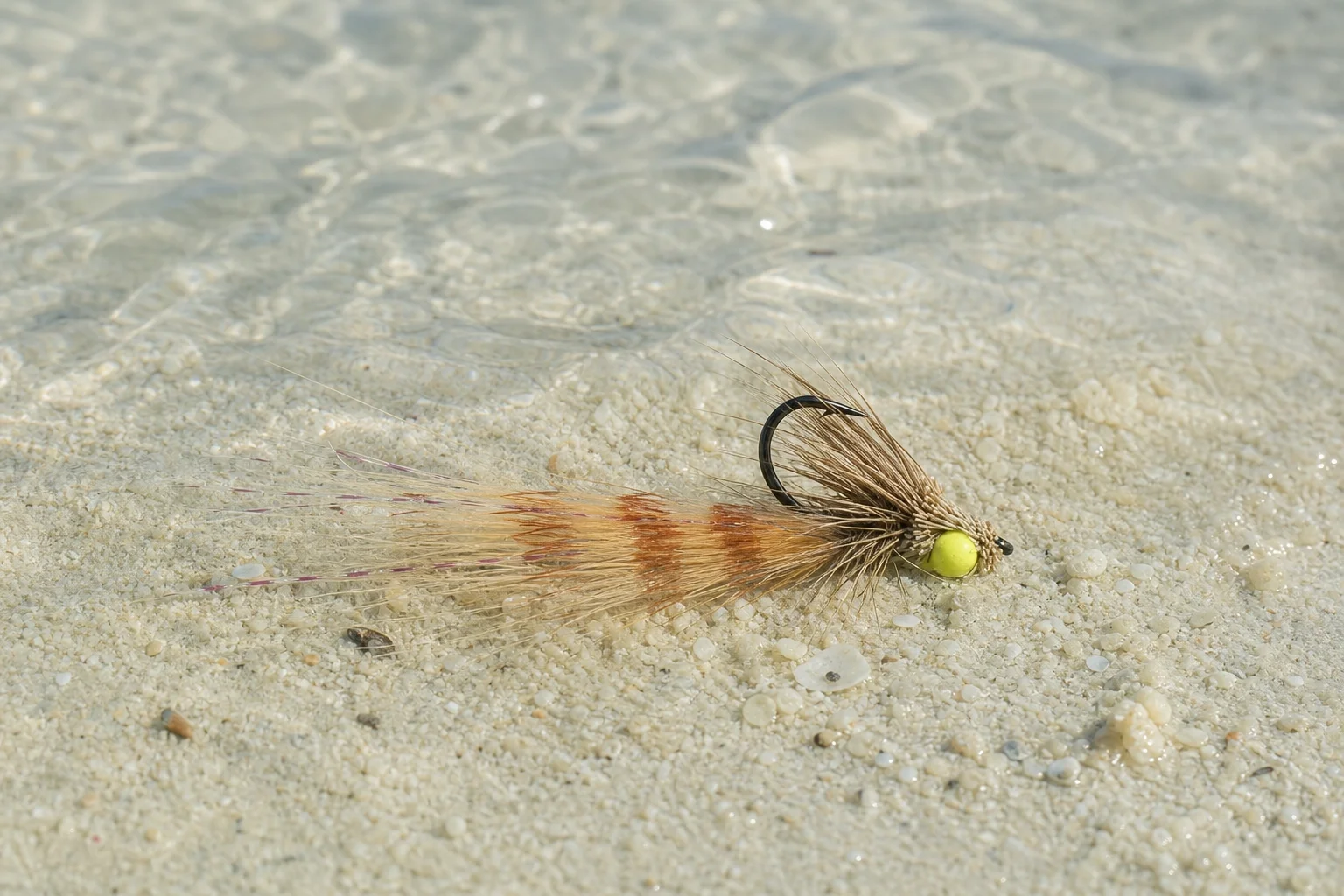 Macro photograph of a Borski's Bonefish Slider fly pattern showing rubber legs and weedless hook-up tie.