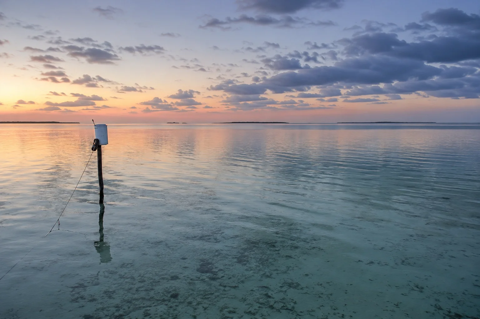 Empty tarpon flats at dawn with skiffs on the horizon