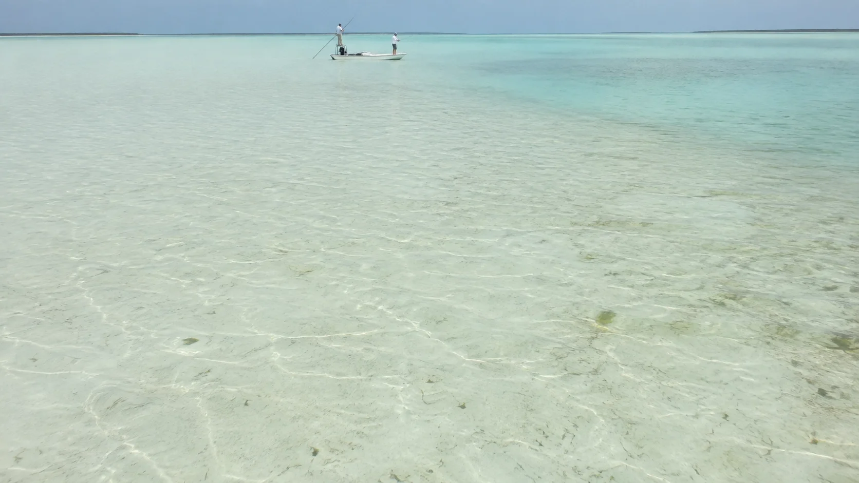 Bahamas bonefish flats with pale shallow water and clean white-sand sight-fishing lanes