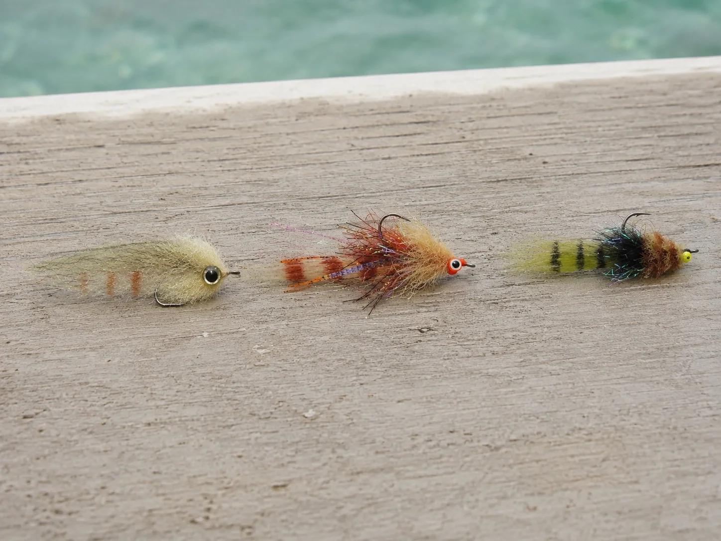 Three redfish fly profiles: shrimp, crab, and baitfish patterns for inshore saltwater fishing