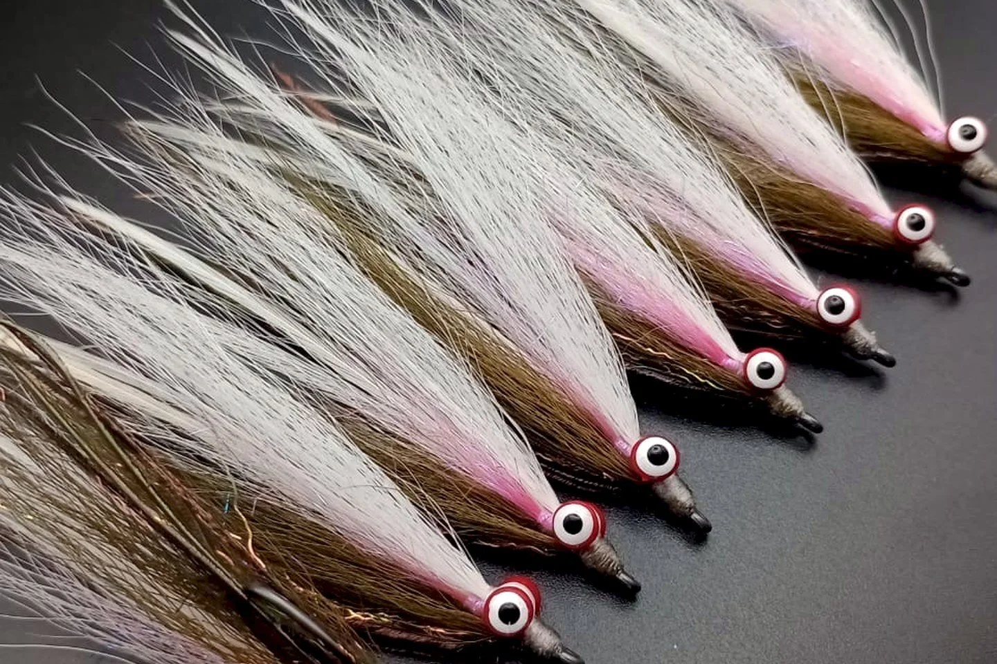 Megafin baitfish flies tied in olive, white and pink
