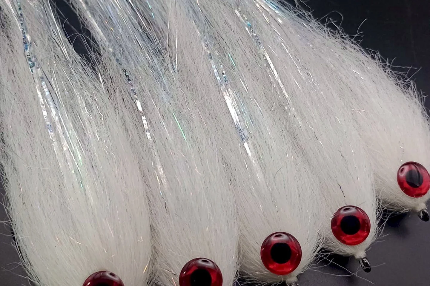 Megafin baitfish flies with red eyes on black
