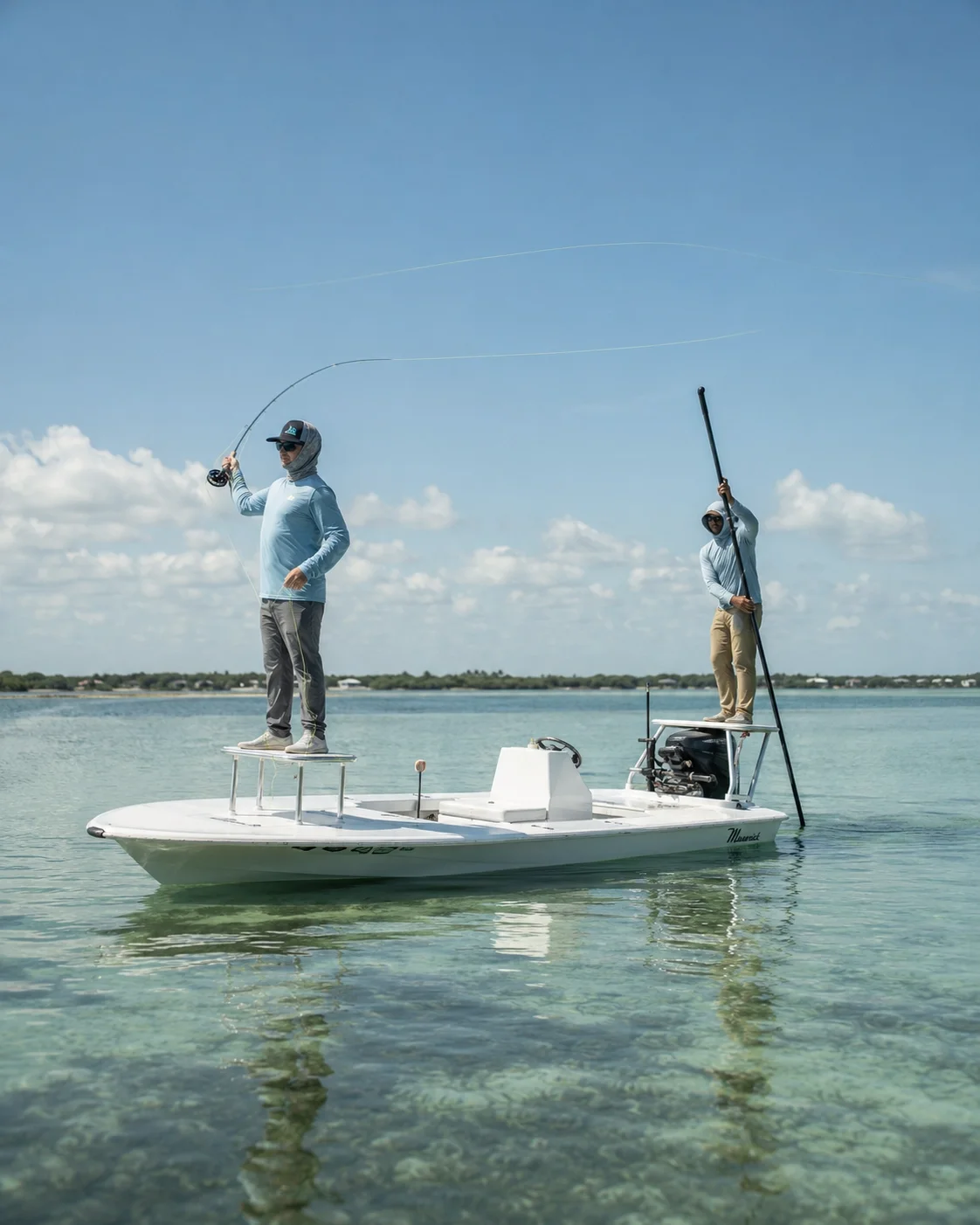 Fly angler mid-cast for tarpon while a guide poles the skiff