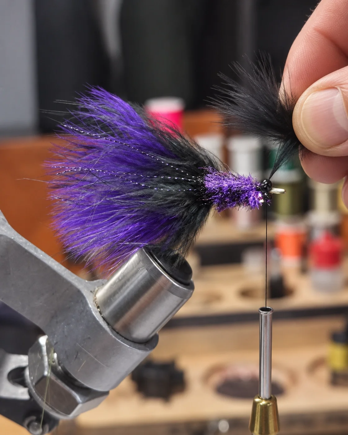 A predator fly being built at the vise, material layering to form the profile