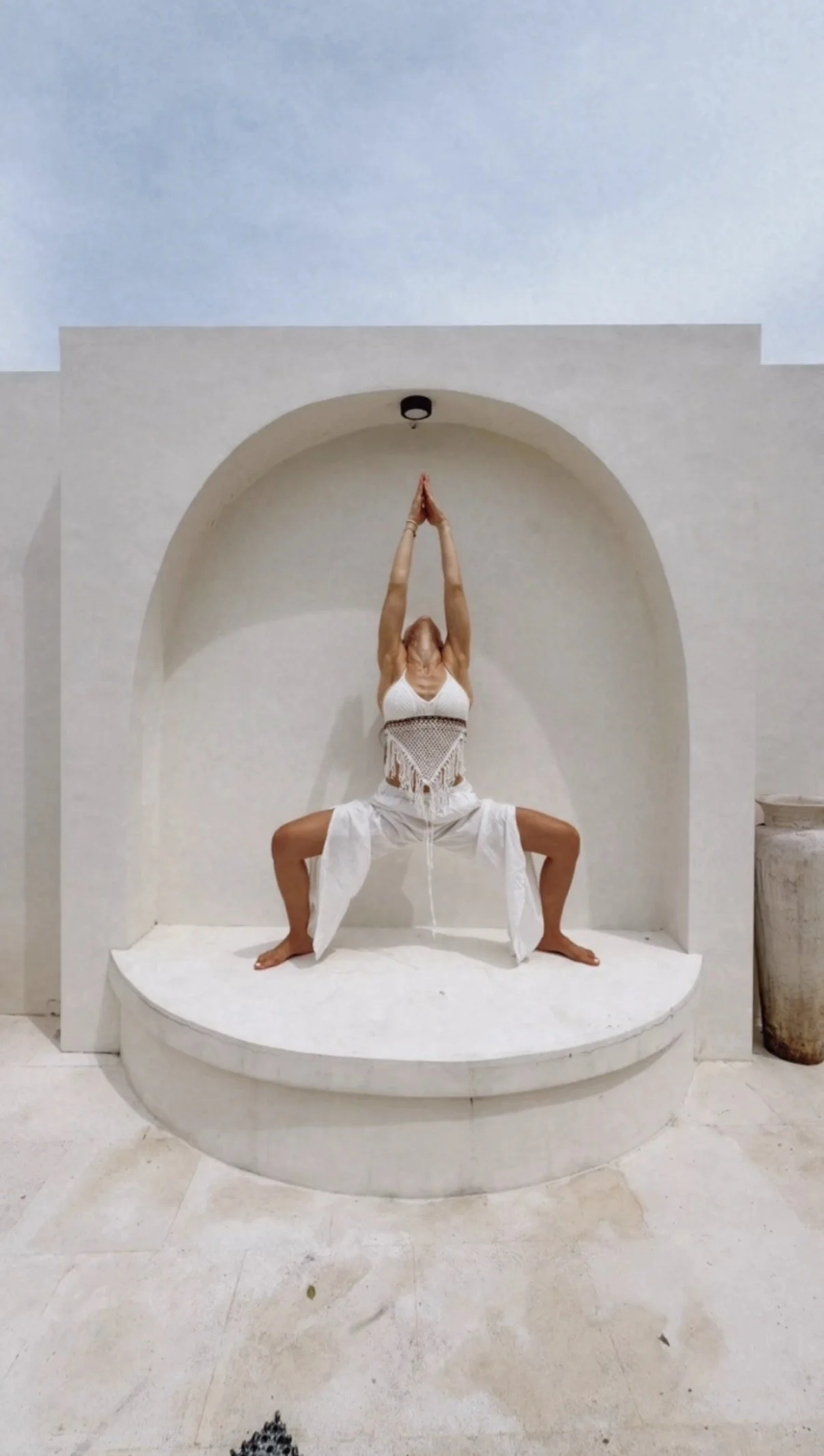 Mia in warrior pose Bali arch