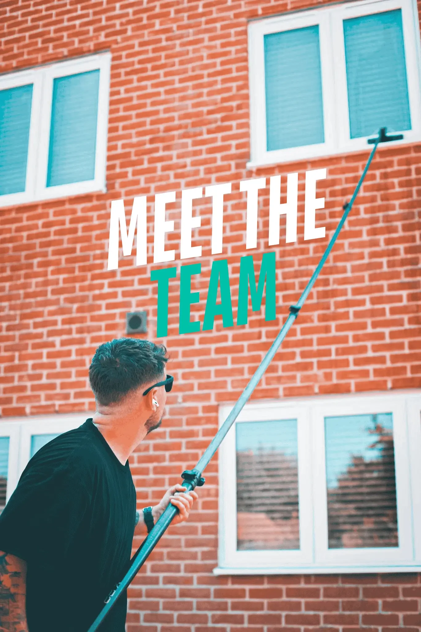 Ben, owner of BA Window Cleaning, cleaning windows in Colchester