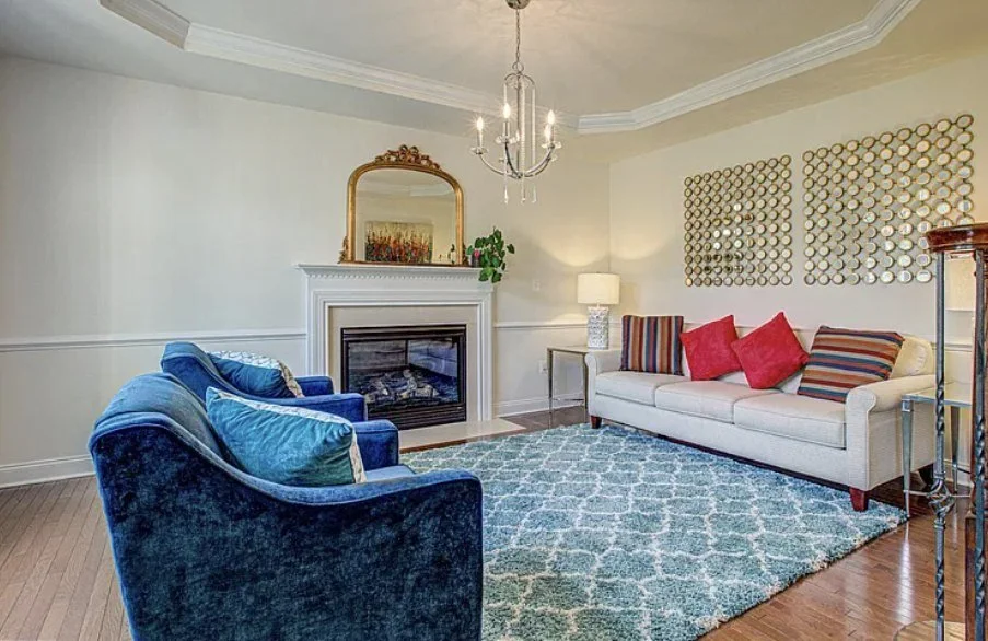 A living room with a fireplace in a Spotsylvania home listed by Nana Noi
