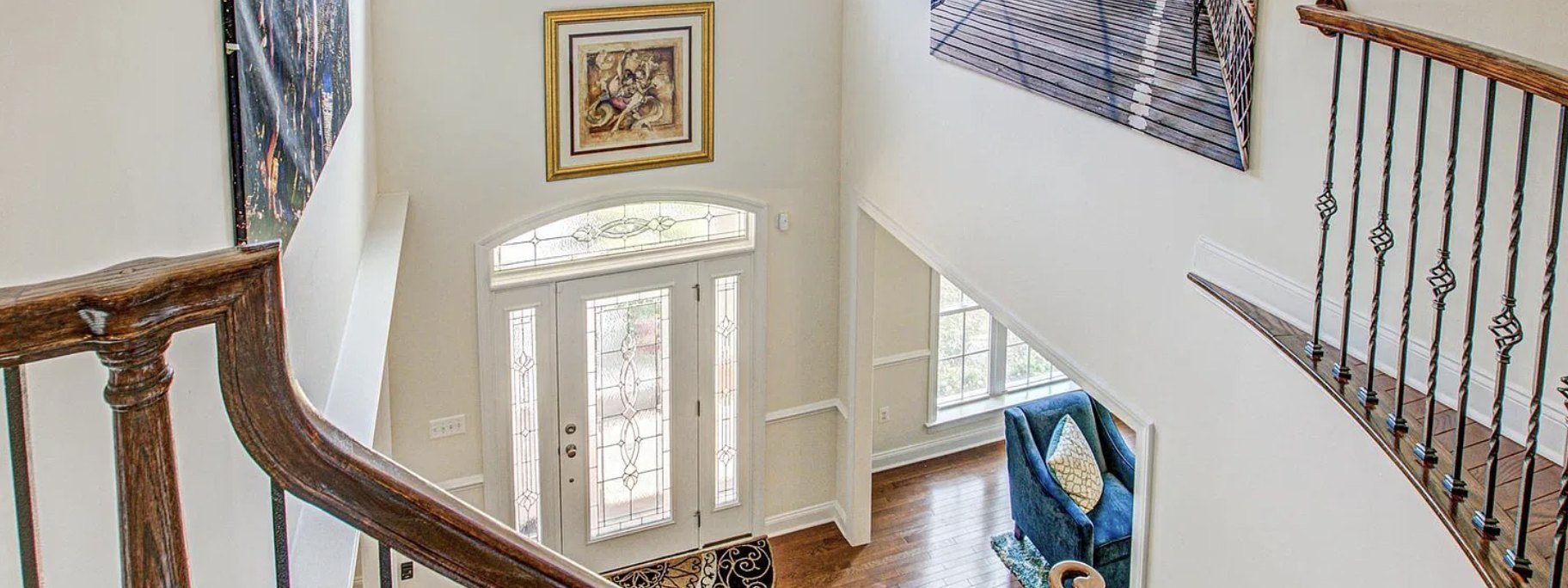 A two-story entrance hall in a home listed by Nana Noi