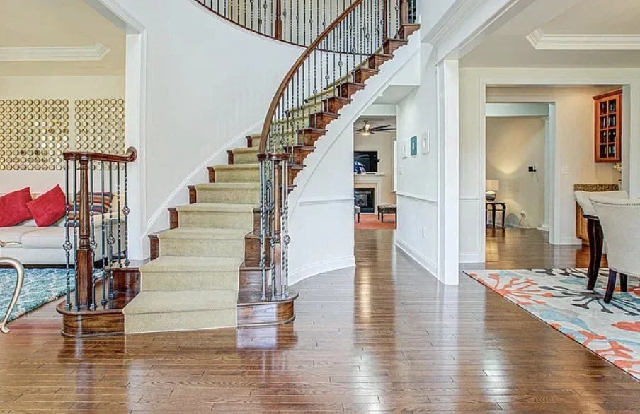 A curved staircase in a Spotsylvania home listed by Nana Noi