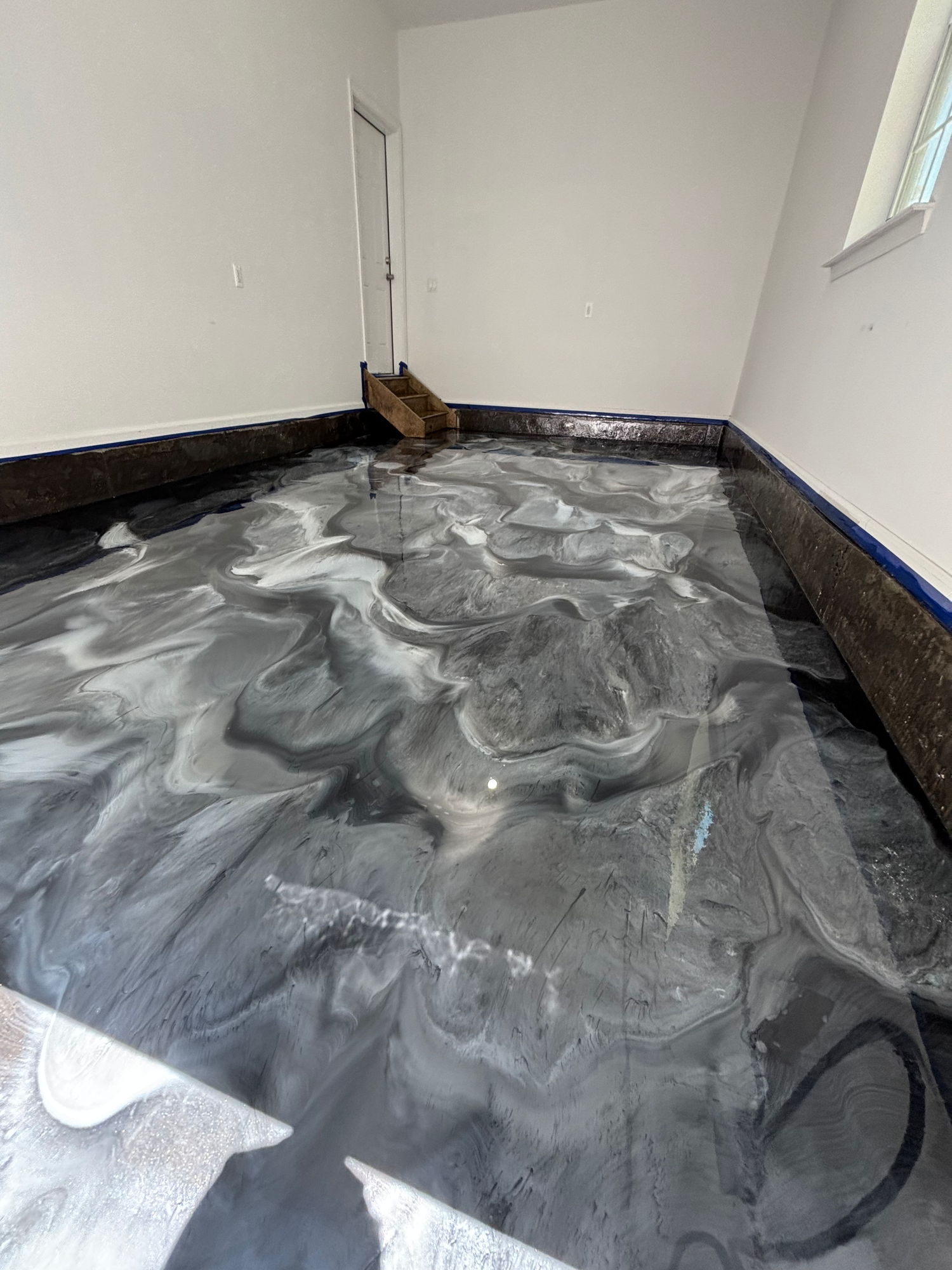 Silver and black metallic epoxy floor with marbled movement