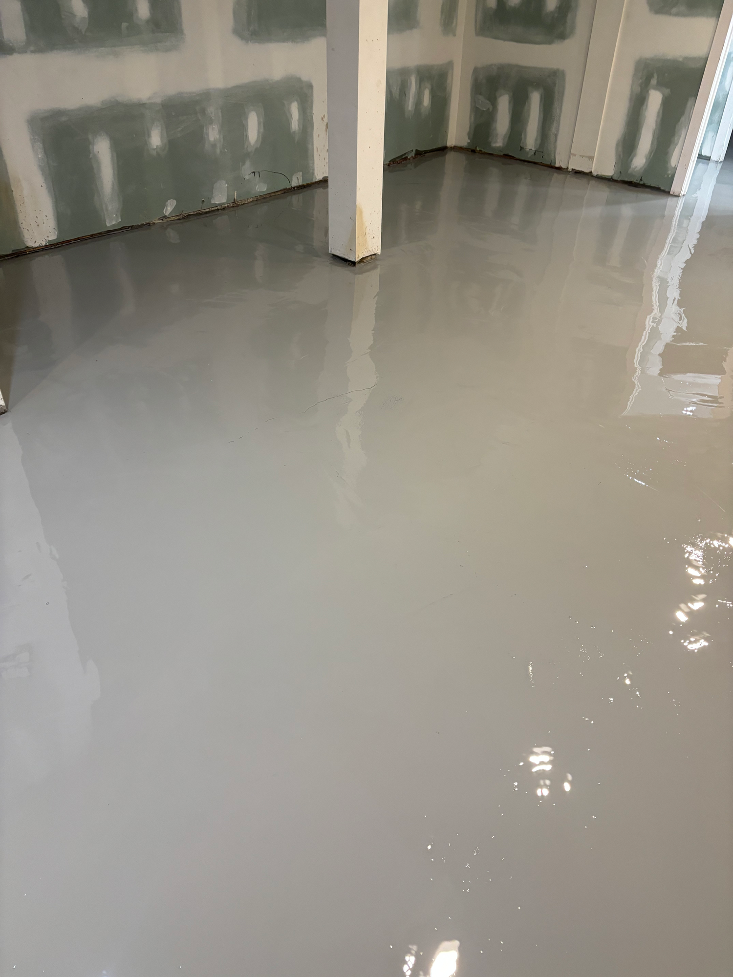 Self-leveling underlayment poured over a prepared slab by Resin Pros