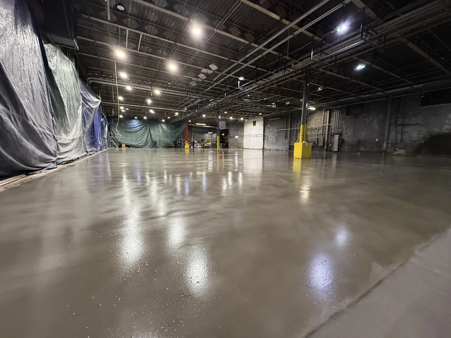 Large-format polished concrete floor in an industrial warehouse