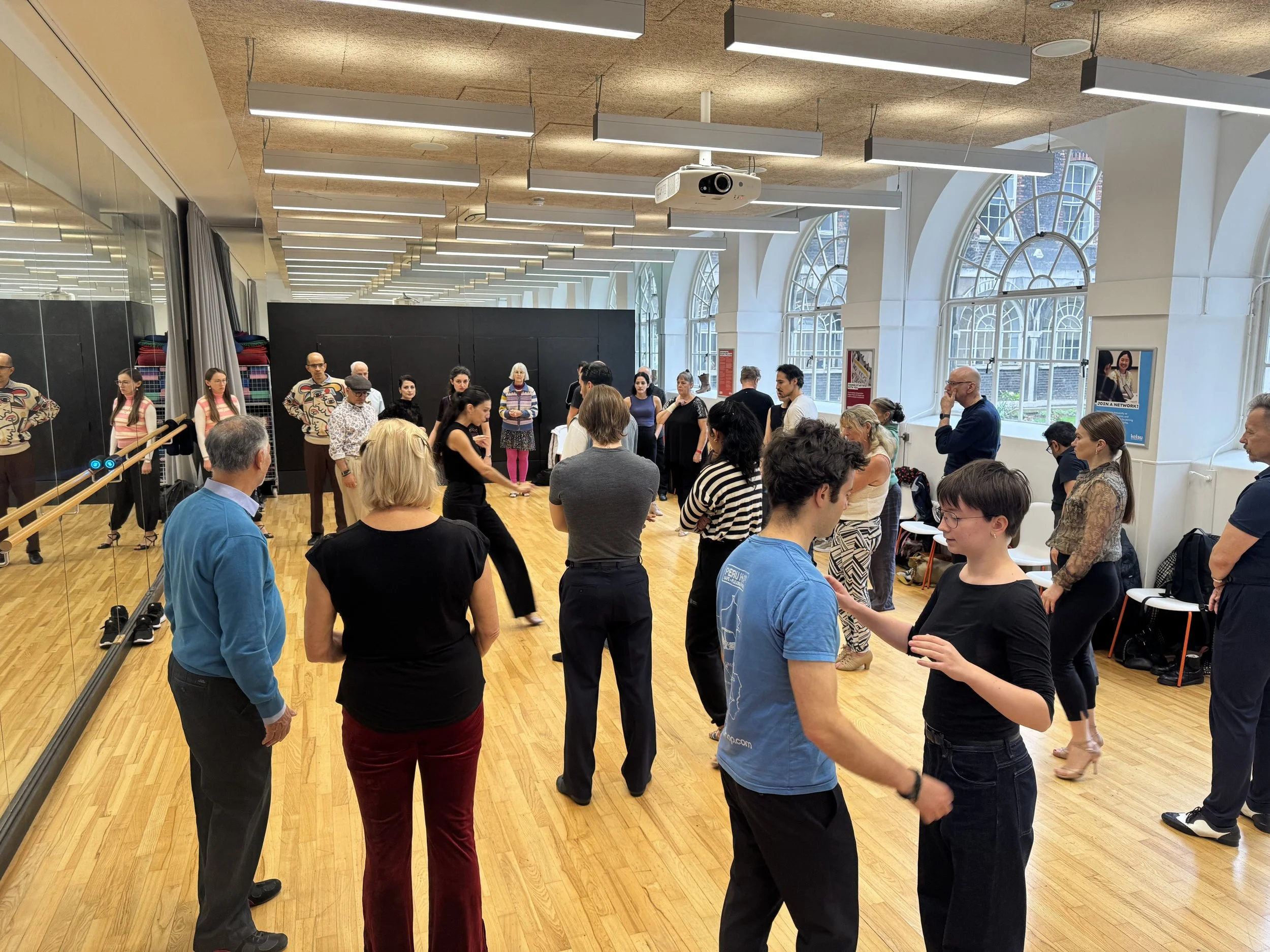 Participants practising partner work during an Alma de Tango workshop
