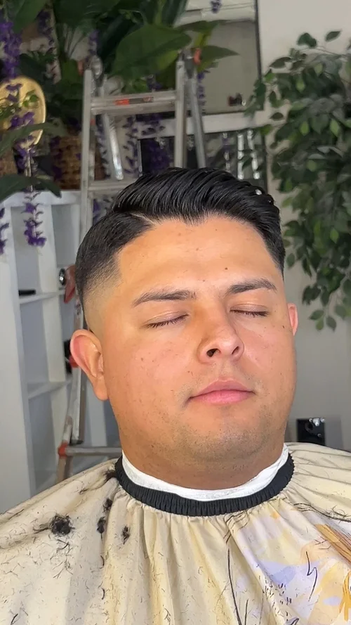 Slick back with low taper fade at The Exclusive Chair, Tucson