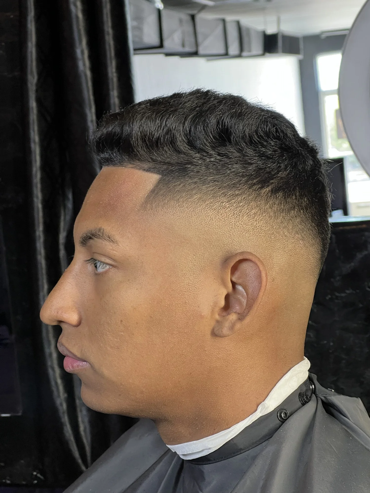 Mid fade with textured top at The Exclusive Chair, Tucson
