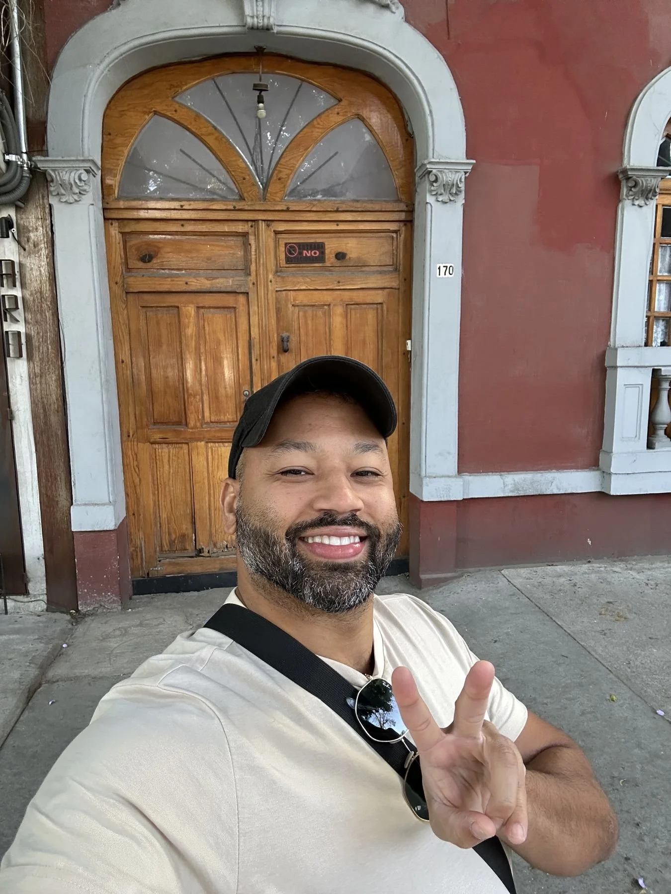 Mexico City travel – peace-sign selfie at the carved wooden door