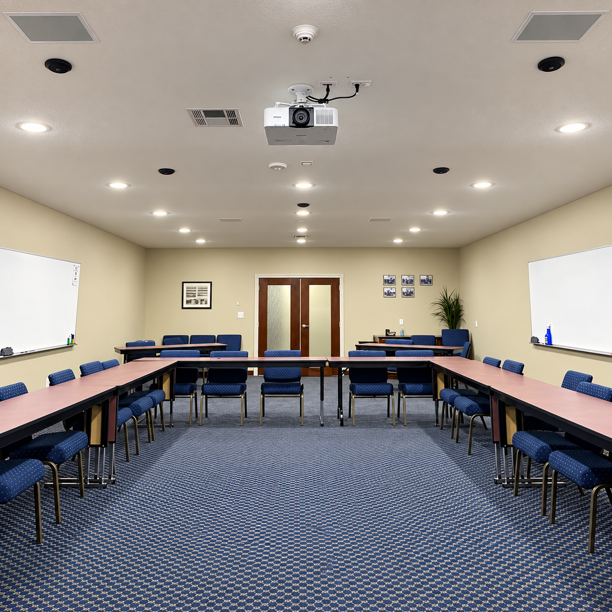 Conference room with ceiling-mounted projector and installed speakers