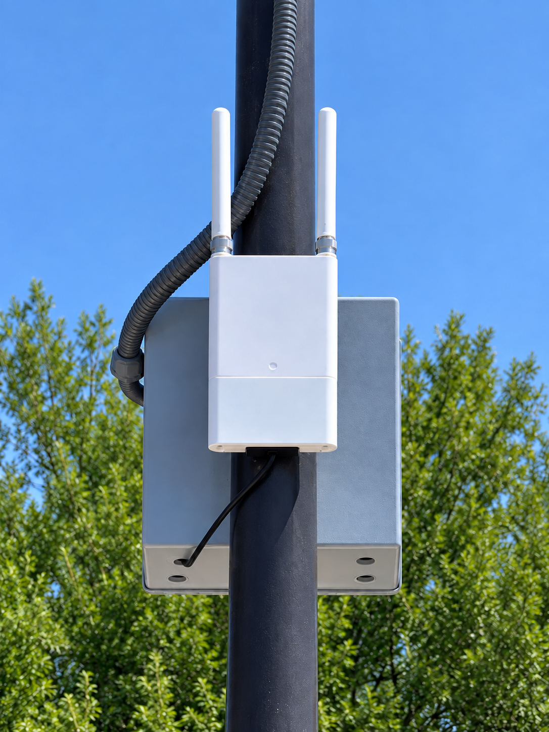 White outdoor wireless gateway with two antennas mounted on a pole