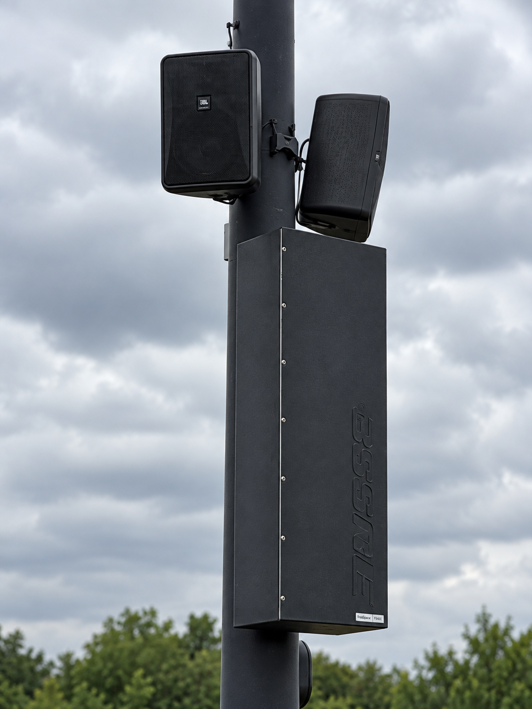 Outdoor speakers mounted on a pole
