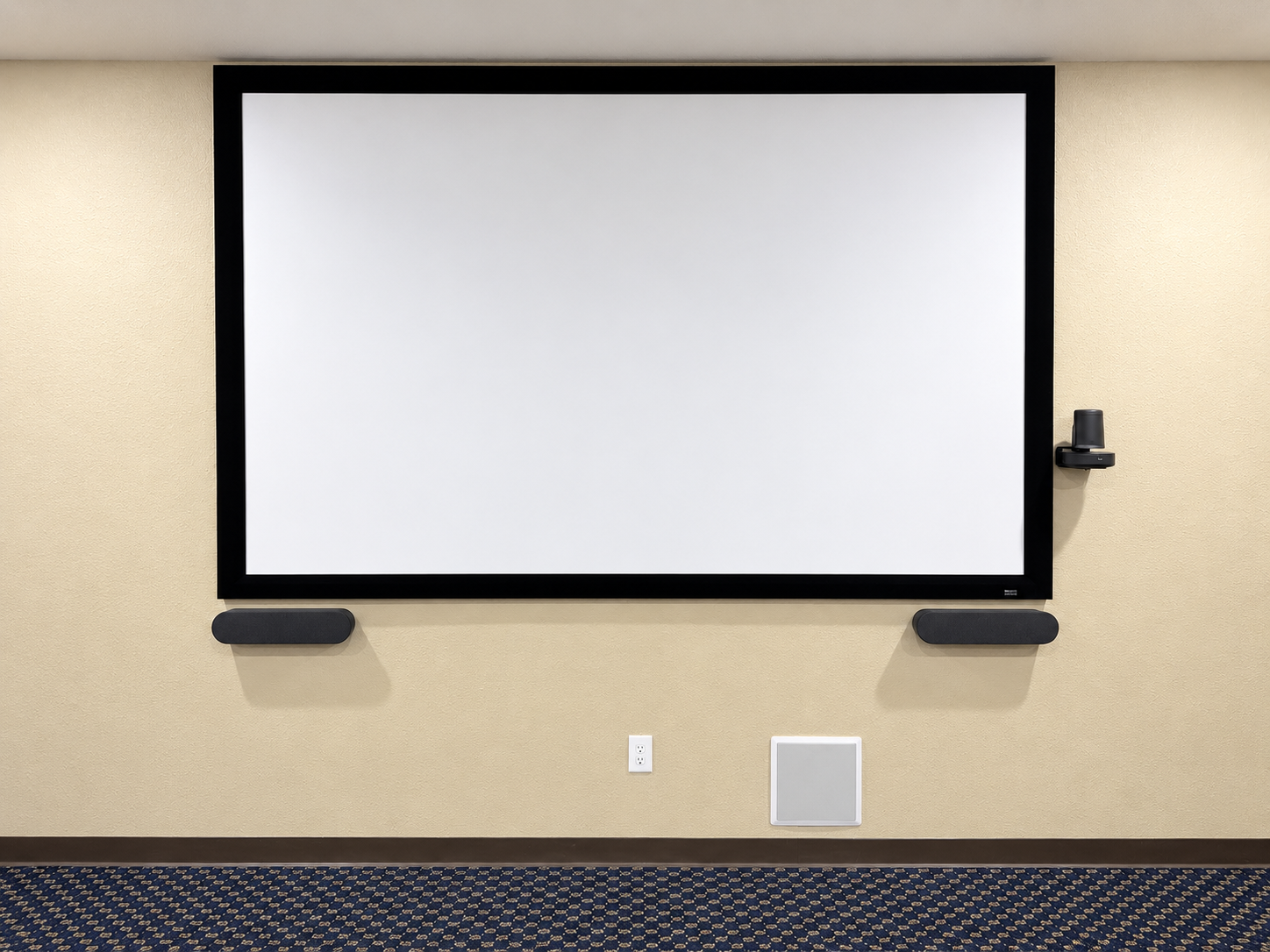 Large projection screen with speakers and a wall-mounted conference camera