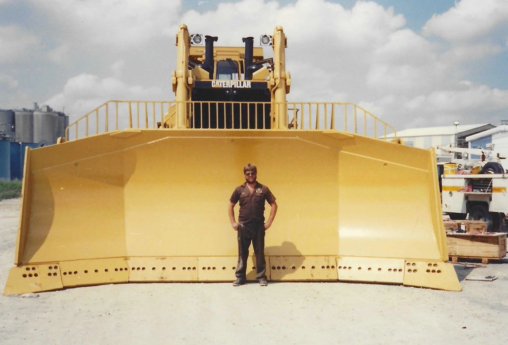 Our founder’s father in his work uniform standing in front of a Caterpillar bulldozer