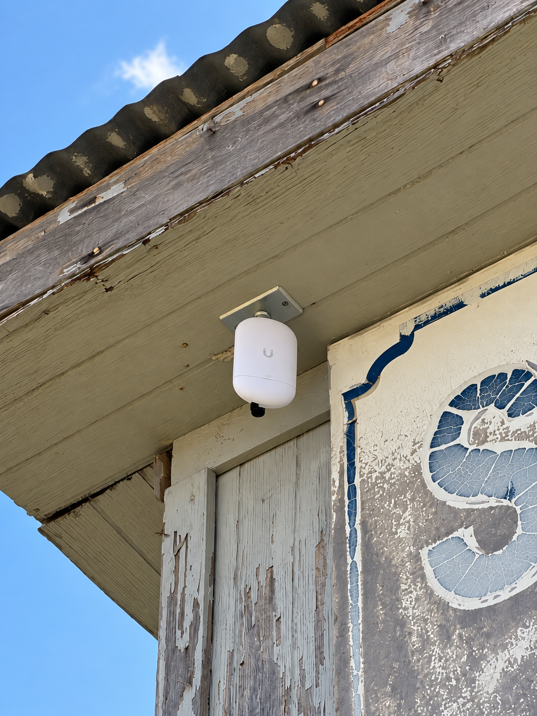 Ubiquiti wireless bridge mounted beneath a building eave