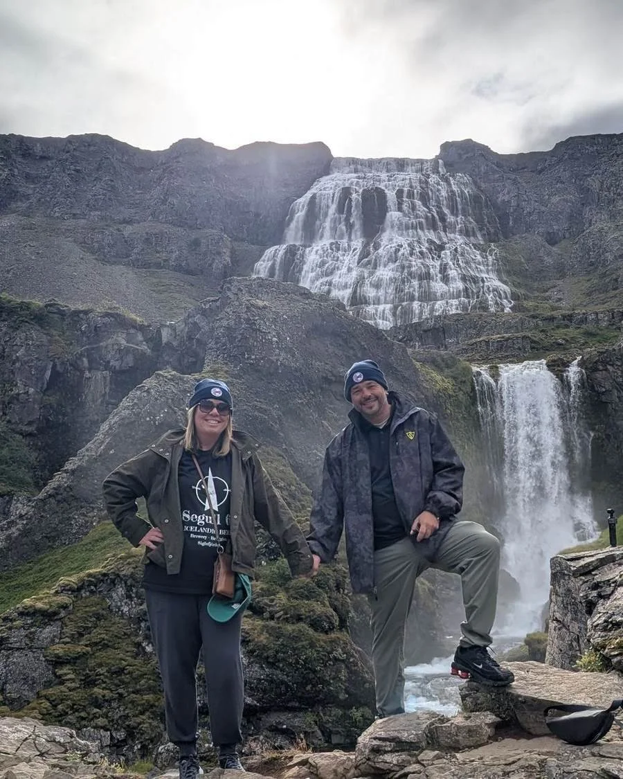 Jay and Becca Dill, owners of The Travel Junkie, at Dynjandi waterfall, Westfjords, Iceland
