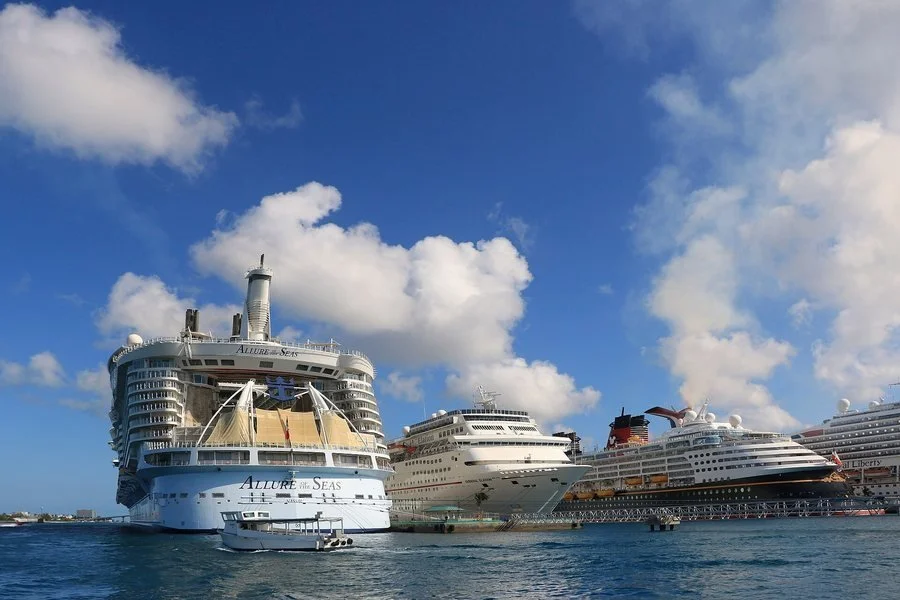 Cruise ships docked in port under a blue sky