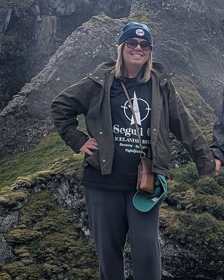 Becca Dill, co-owner of The Travel Junkie, at Dynjandi waterfall in Iceland's Westfjords