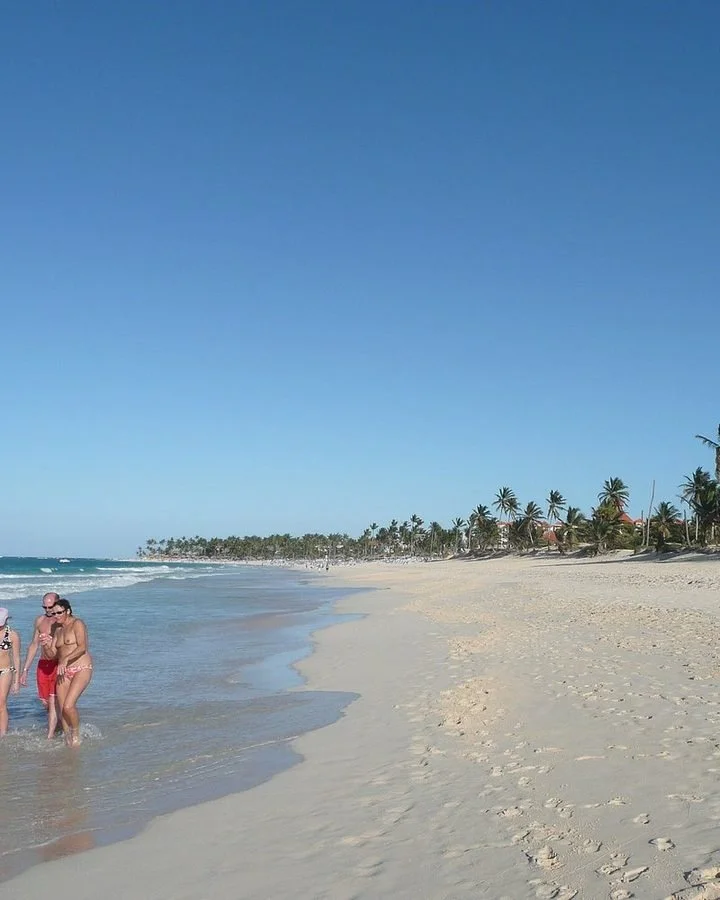 Wide sandy beach and turquoise water along the coast at Punta Cana