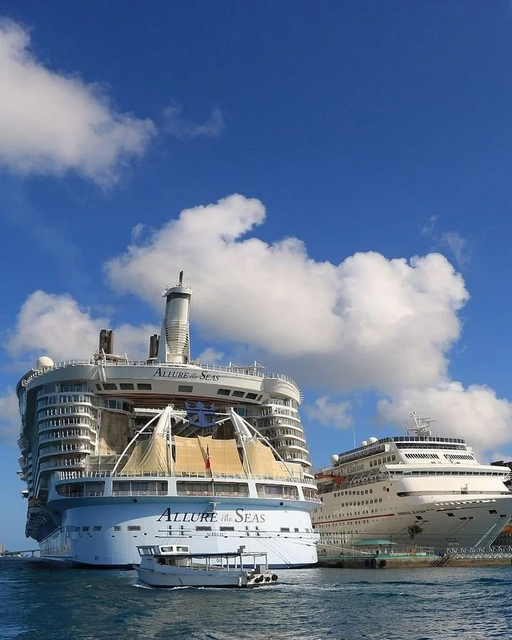 Large cruise ships docked under a bright blue sky in Nassau, Bahamas