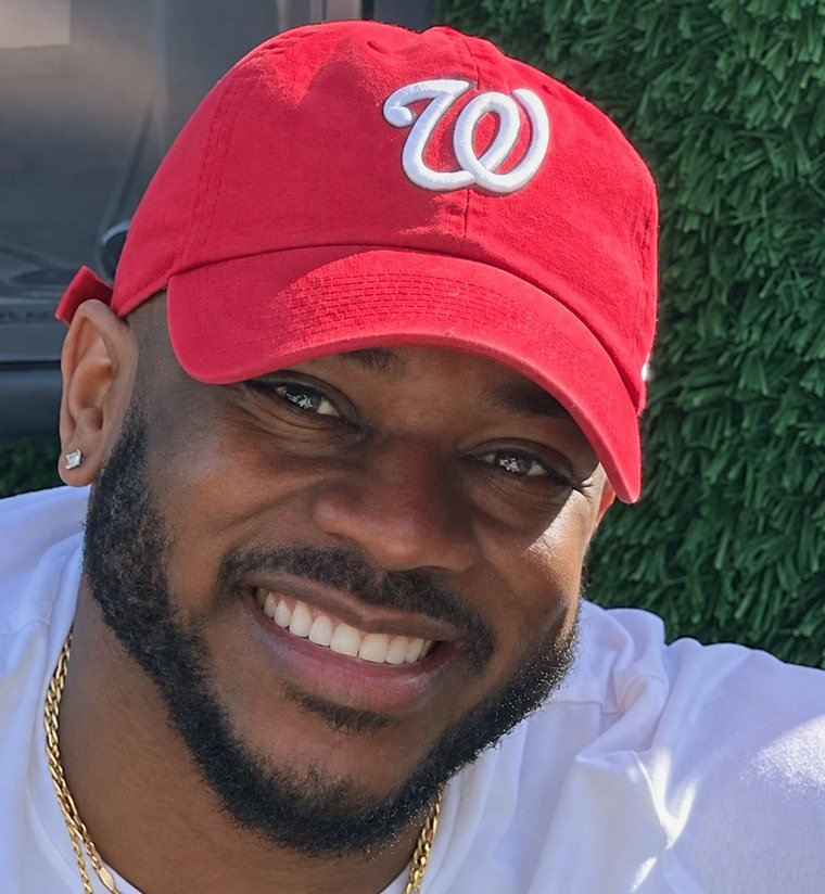 Mike Randle smiling in a red cap