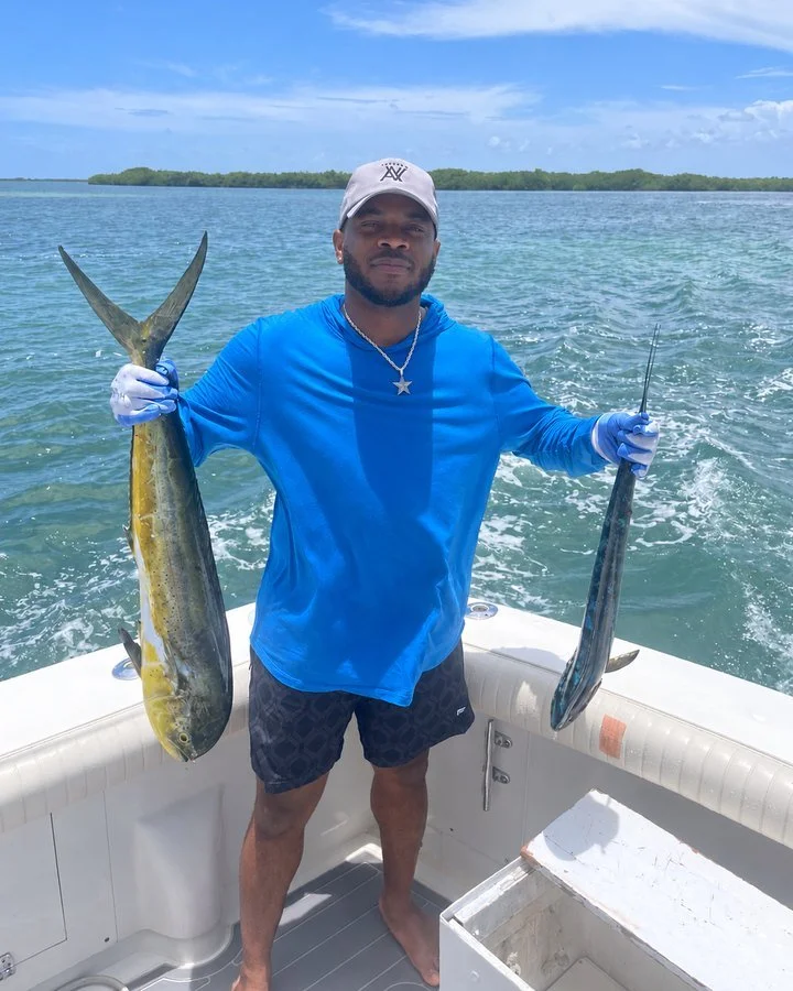 Mike Randle, Travel Junkie advisor, holding two fish on a boat