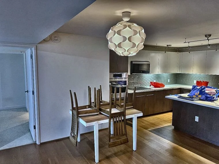 Kitchen area mid-move with chairs stacked on table