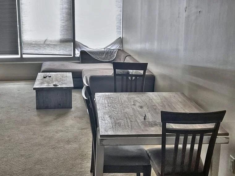 Worn furniture and cluttered room before move-out