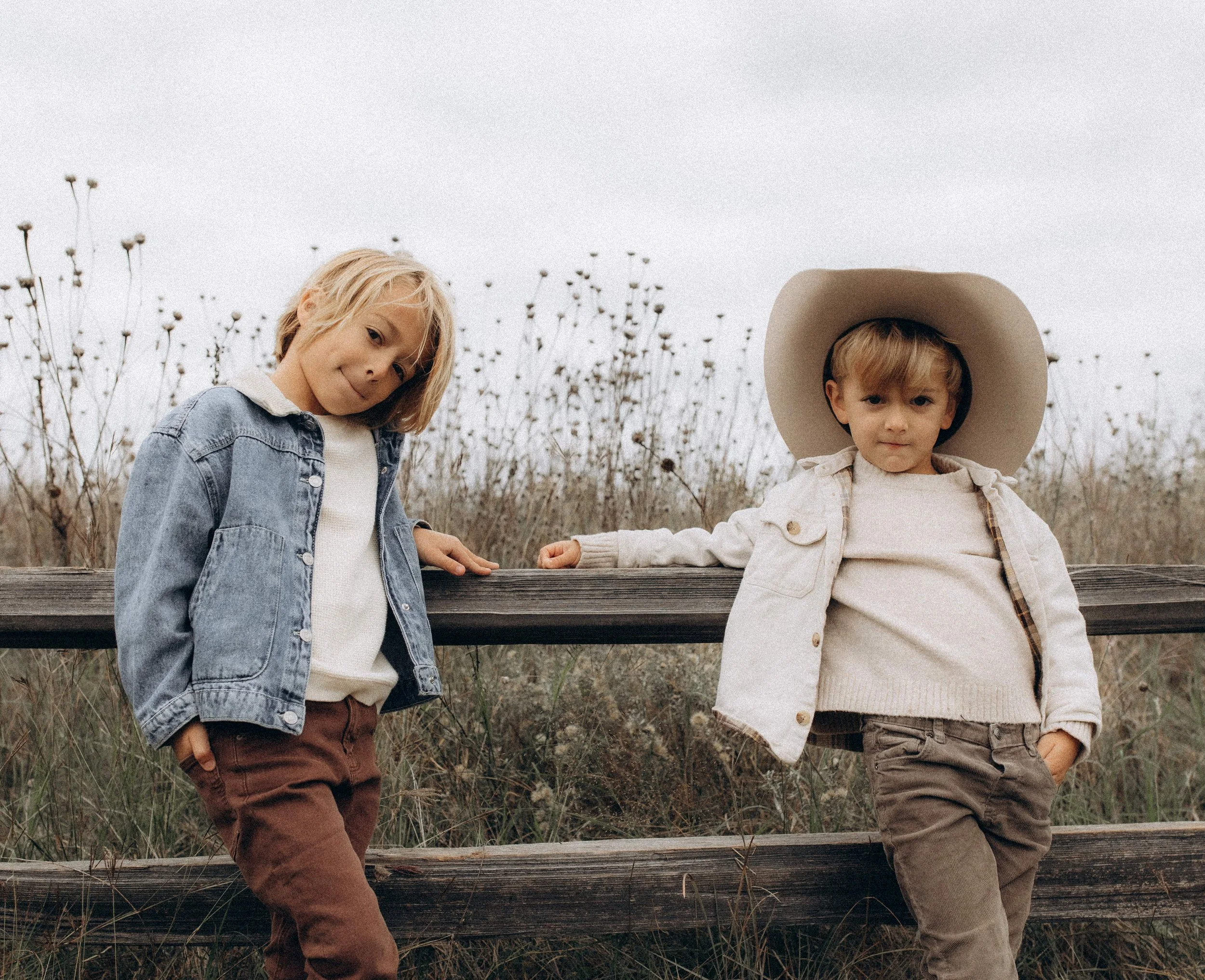 Kimberly's two boys at a wooden fence
