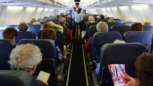 Airplane cabin interior with rows of seats, representing fear of flying and travel anxiety