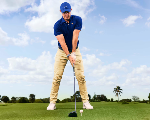 Golfer focusing over the ball before a drive, representing sports hypnotherapy for golf and athletic performance