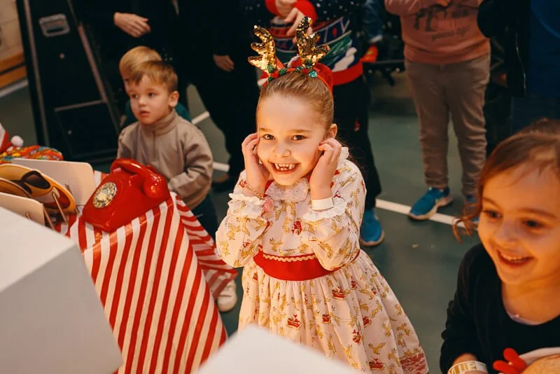 Father Christmas greeting a child at the Forward Facing Christmas party