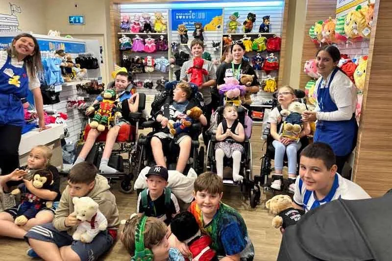 Staff and families gathered for a group photo at the Memory Bear event