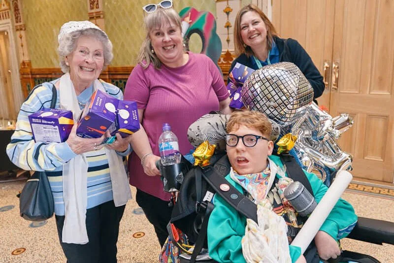 A family leaving Memory Making Day in Brighton laden with goodies