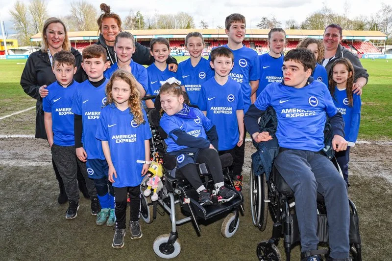 A group photo of children and volunteers as a football team at a Forward Facing event