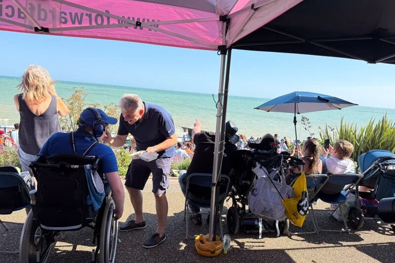 Families and wheelchair users watching the airshow from the Forward Facing gazebo by the sea