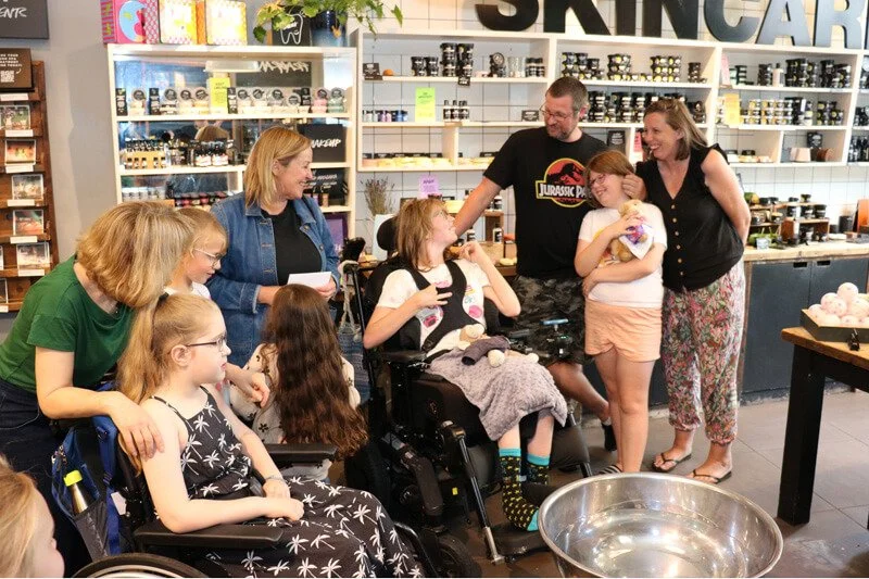 Families smiling and crafting together at a Creative Play day