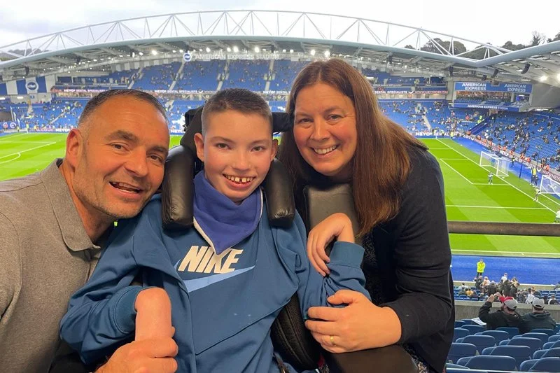 Families enjoying the view inside a football stadium during a Forward Facing event