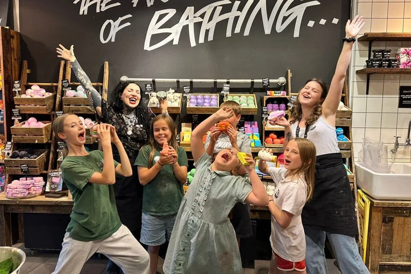 A group of children proudly displaying their art projects