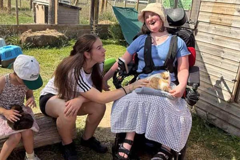 Children meeting a chicken and learning about farm animals during a Forward Facing session