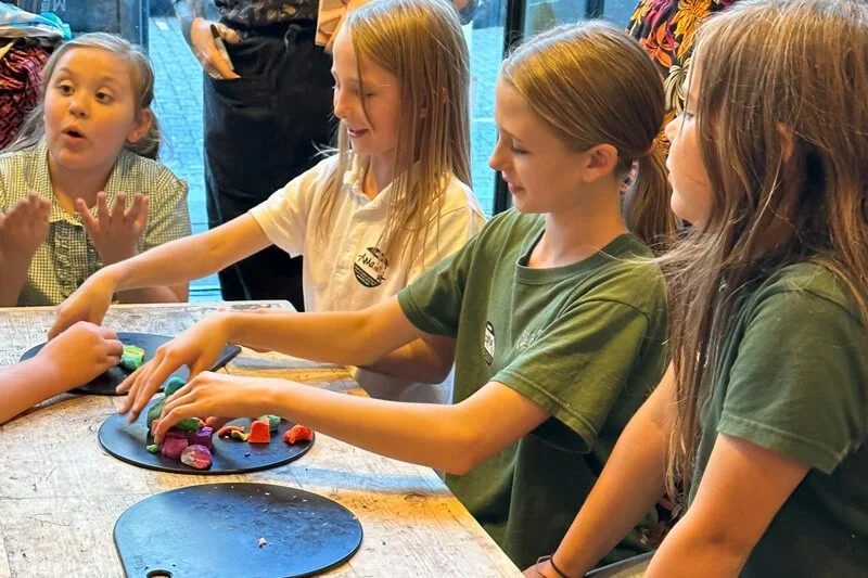 A child creating artwork with colourful paints at a Forward Facing event