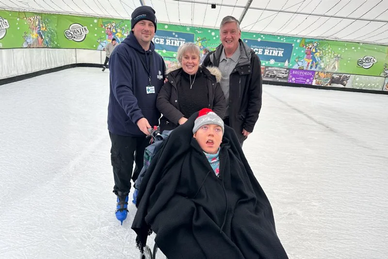A child experiencing adaptive ice skating at a Forward Facing sports event